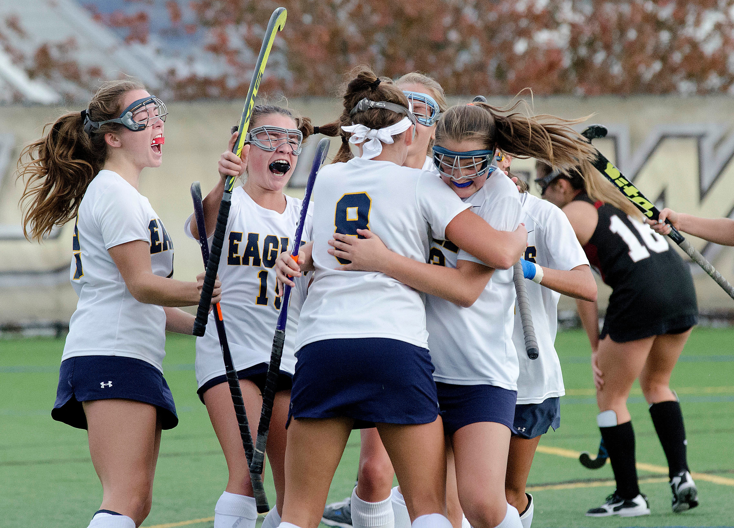 The Eagles celebrate a goal by Maddy Cox (right).