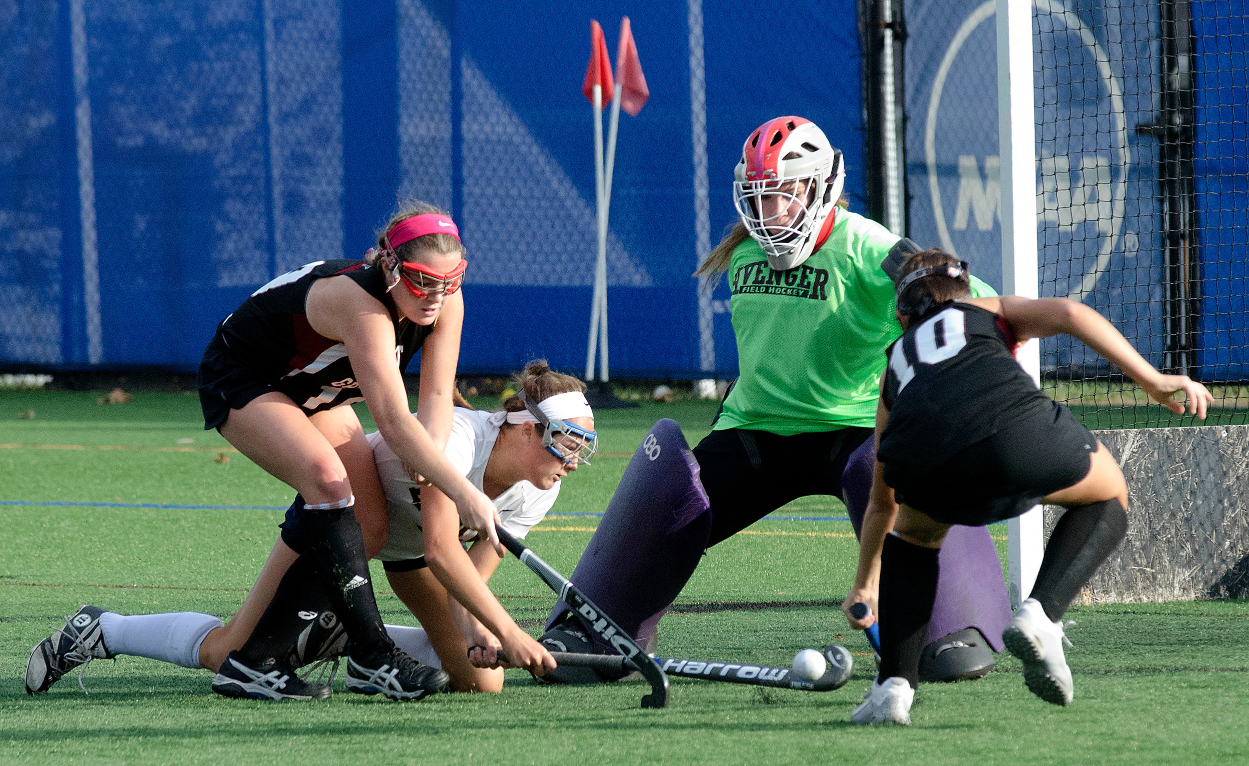 Elizabeth Lewis looks to end the game as she takes a hack at the ball while being pushed down by an Avenger in overtime.