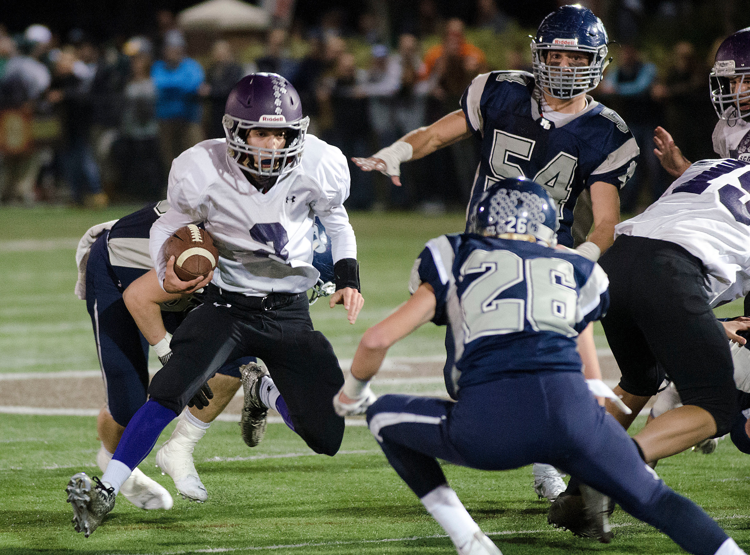 Huskies quarterback Vincent Berretto runs up the middle in the first half.