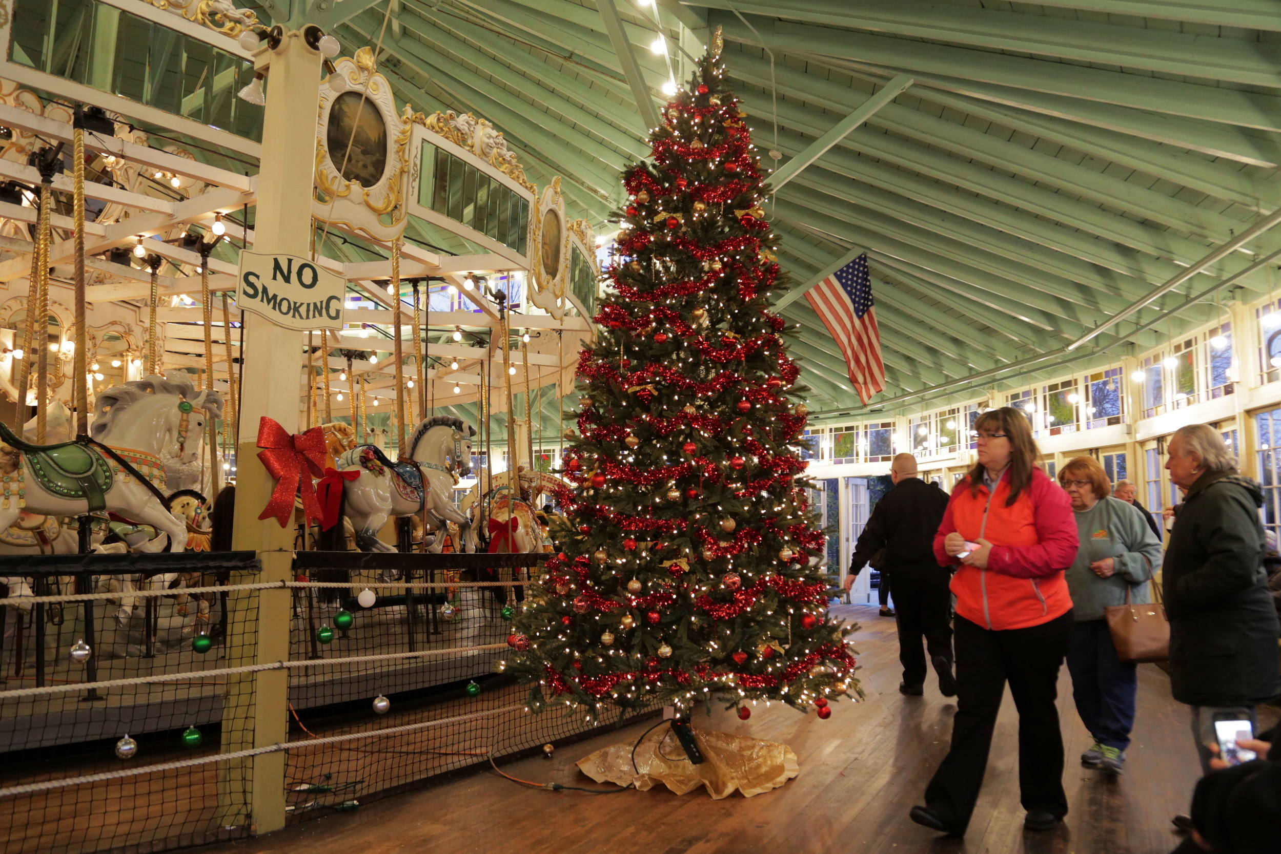The newly illuminated Christmas Tree stands inside the Crescent Park Carousel.