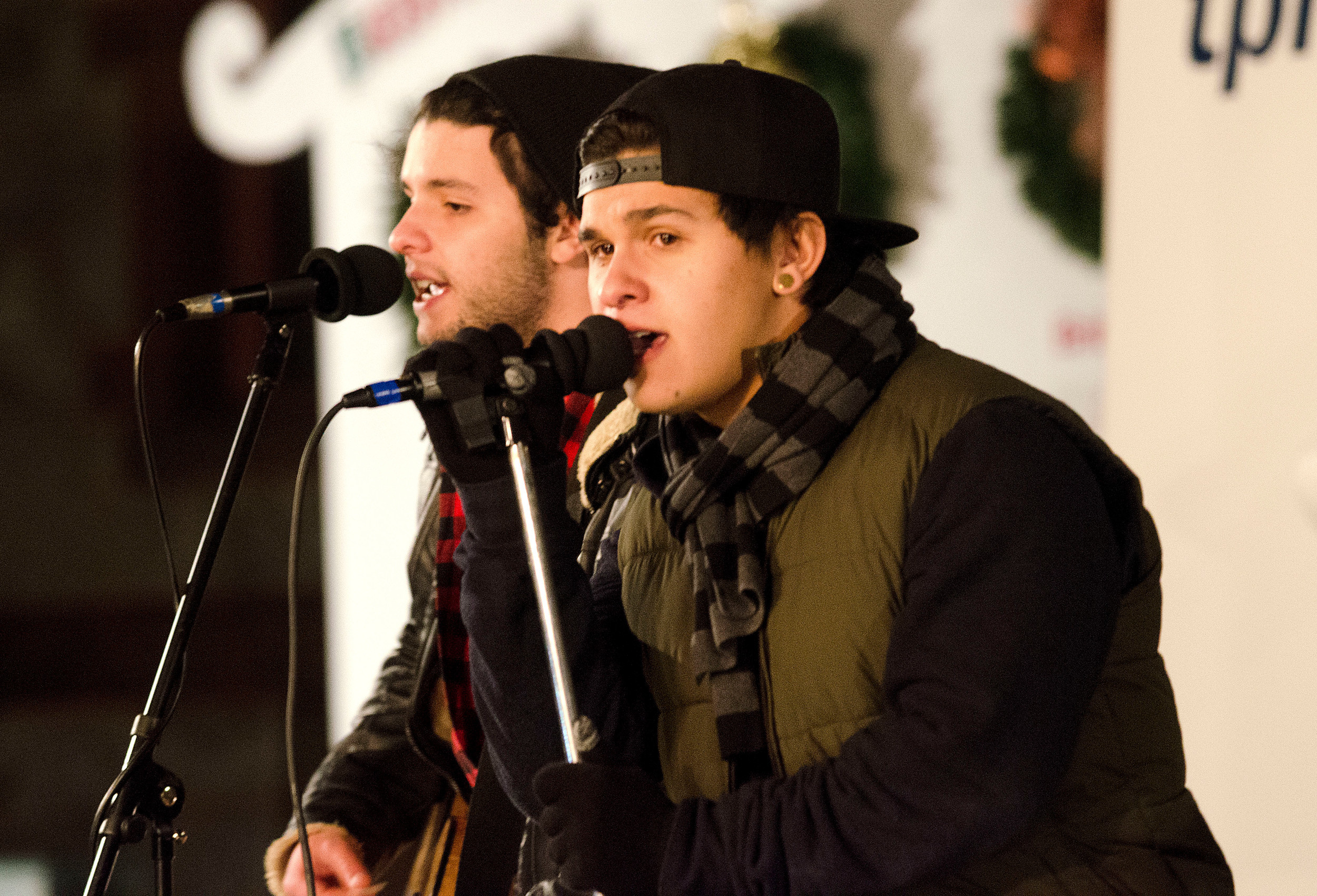Ryan (left) and Tyler Falcoa sing Christmas favorites before the tree lighting.