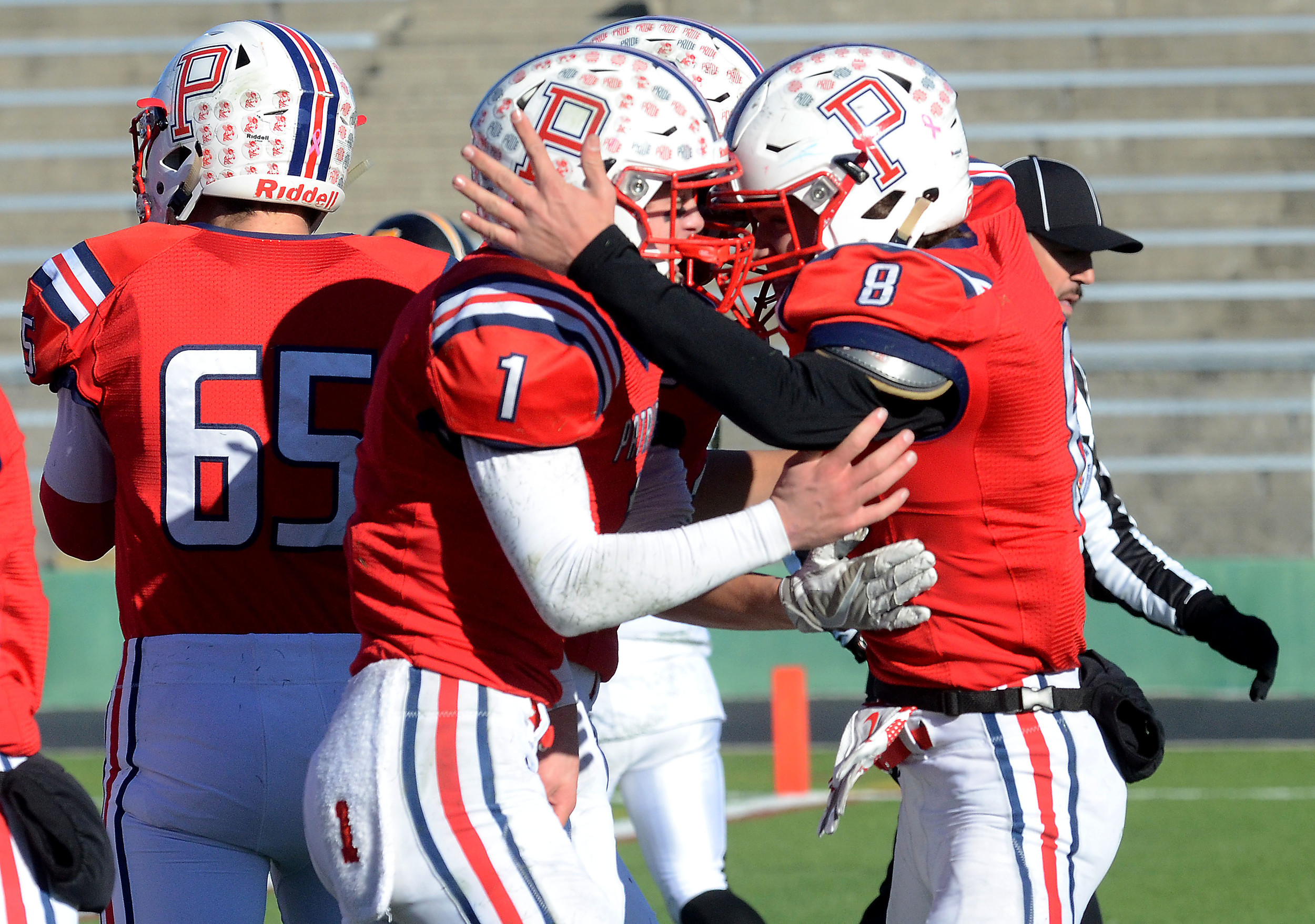 Sean Coyne celebrates with Peyton Robinson after Robinson scored a touchdown in the first half.
