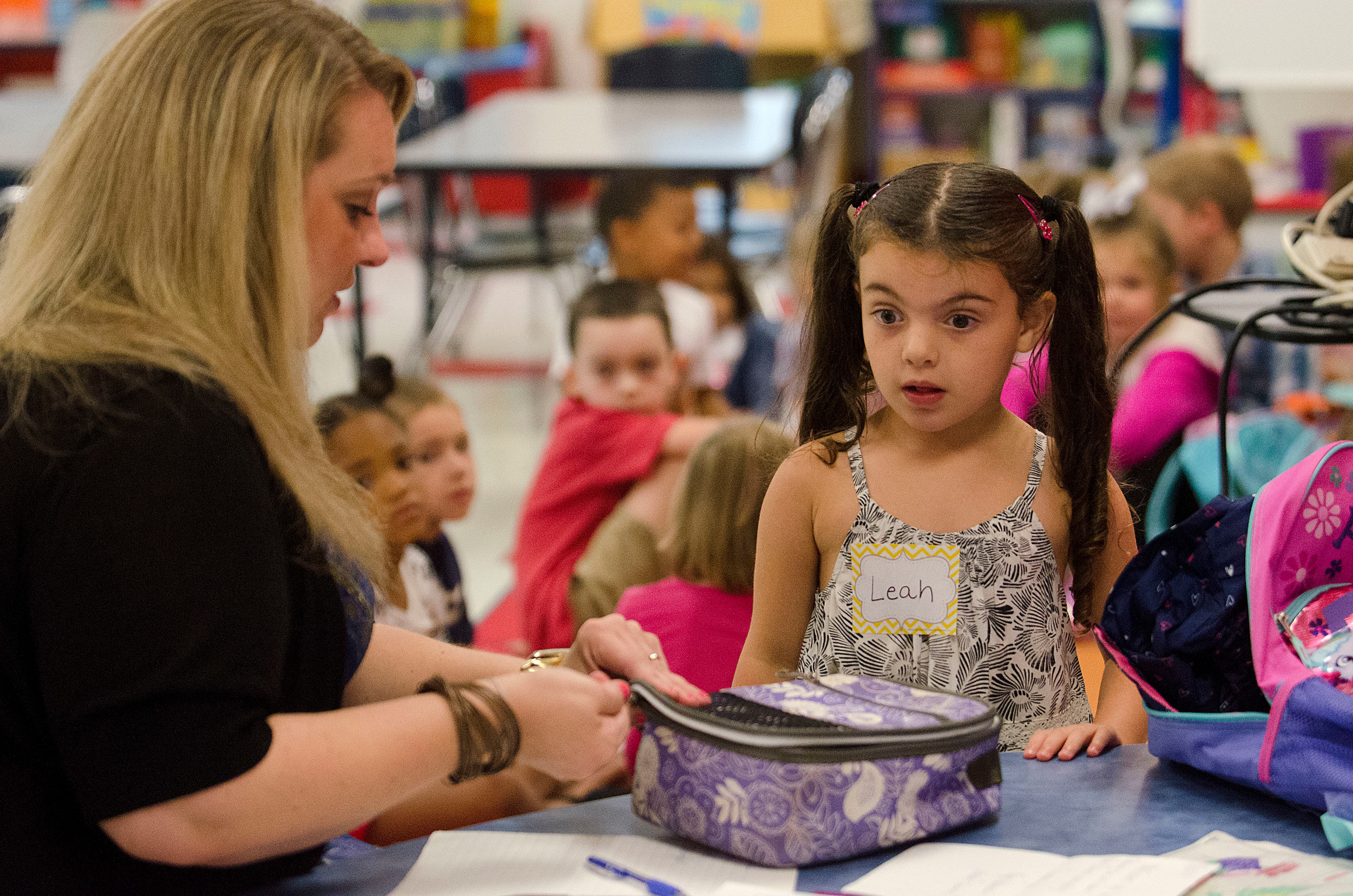Colt-Andrews Elementary School kindergarten teacher Katelyn McCanna gets Leah White ready for her first day of school.