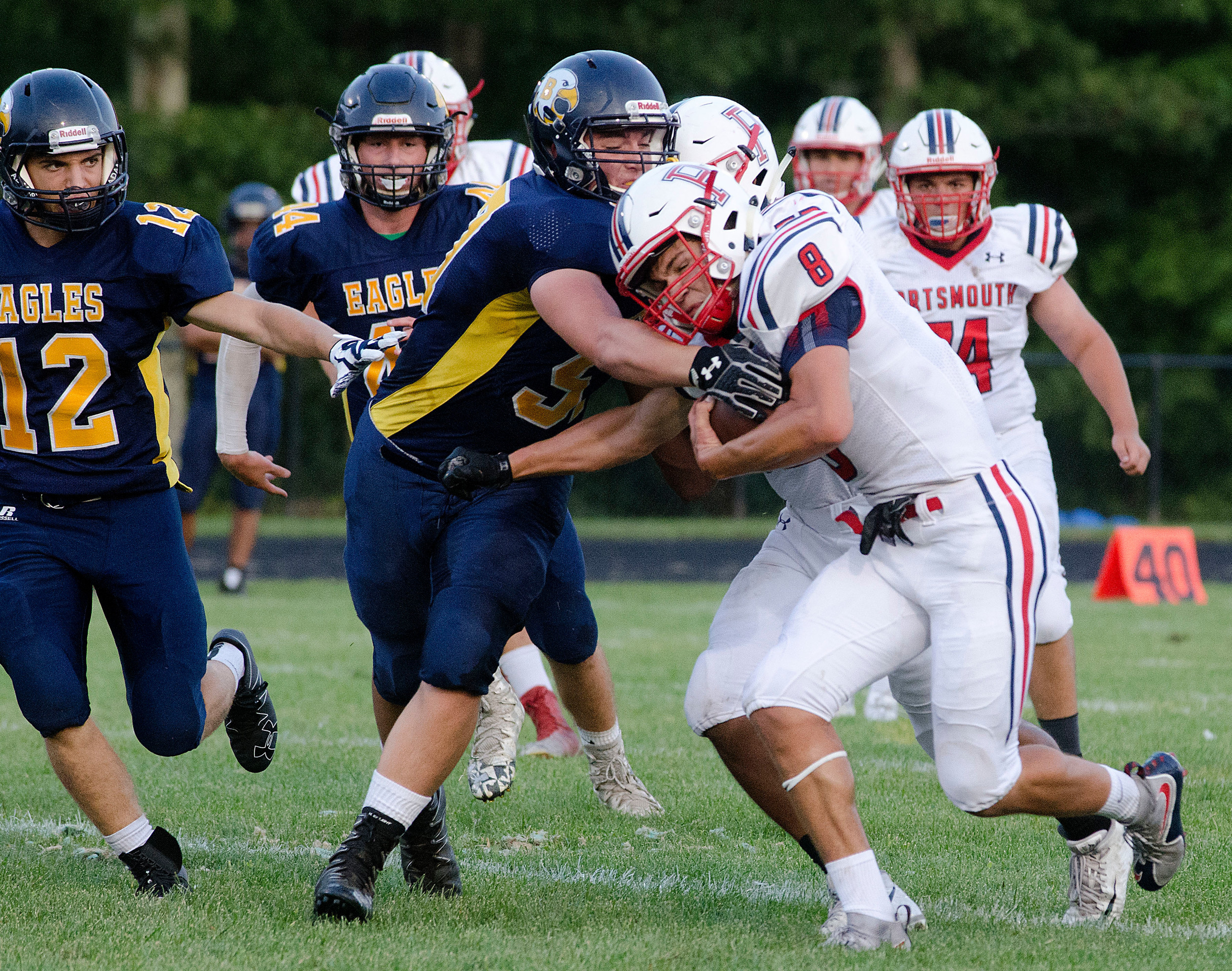 Portsmouth running back powers past a Barrington defender during an Injury Fund game game on Thursday night at Tiverton High School.