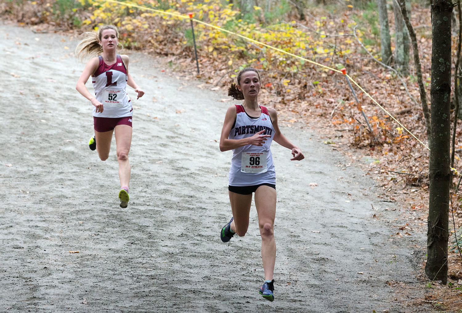 Portsmouth's Nikki Merrill flies down a dirt hill on the wooded part of the course.