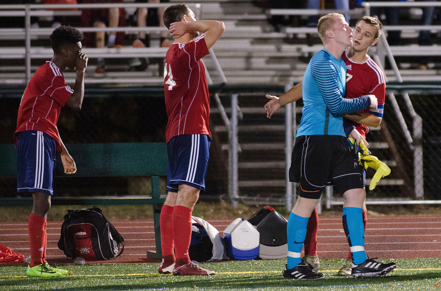 Senior goalkeeper Will Swart (right) and teammates reflect after the loss.