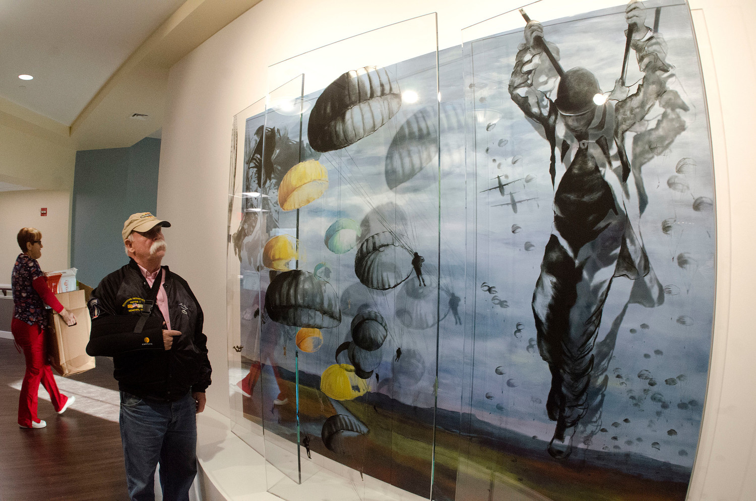 Vietnam veteran Bill McCollum takes in a painting by local artist Deborah Baronas.