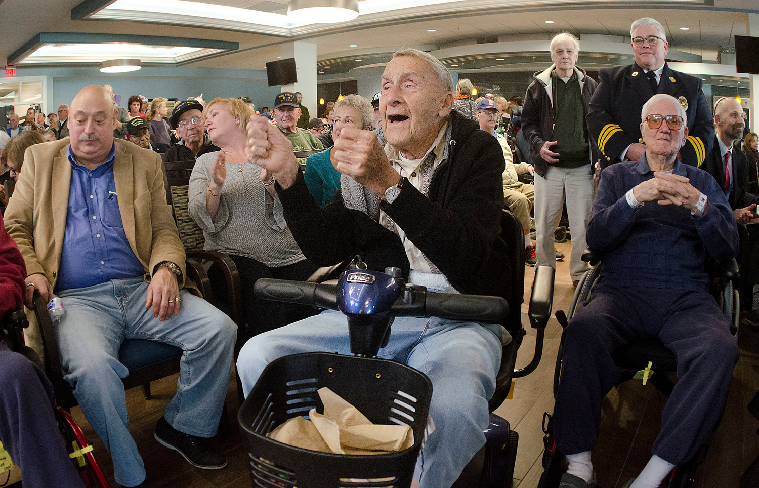 WWII veteran Richard Fisher dances in his wheelchair as the Mt. Hope High School band plays the Armed Forces medley during the Veteran’s Day ceremony.