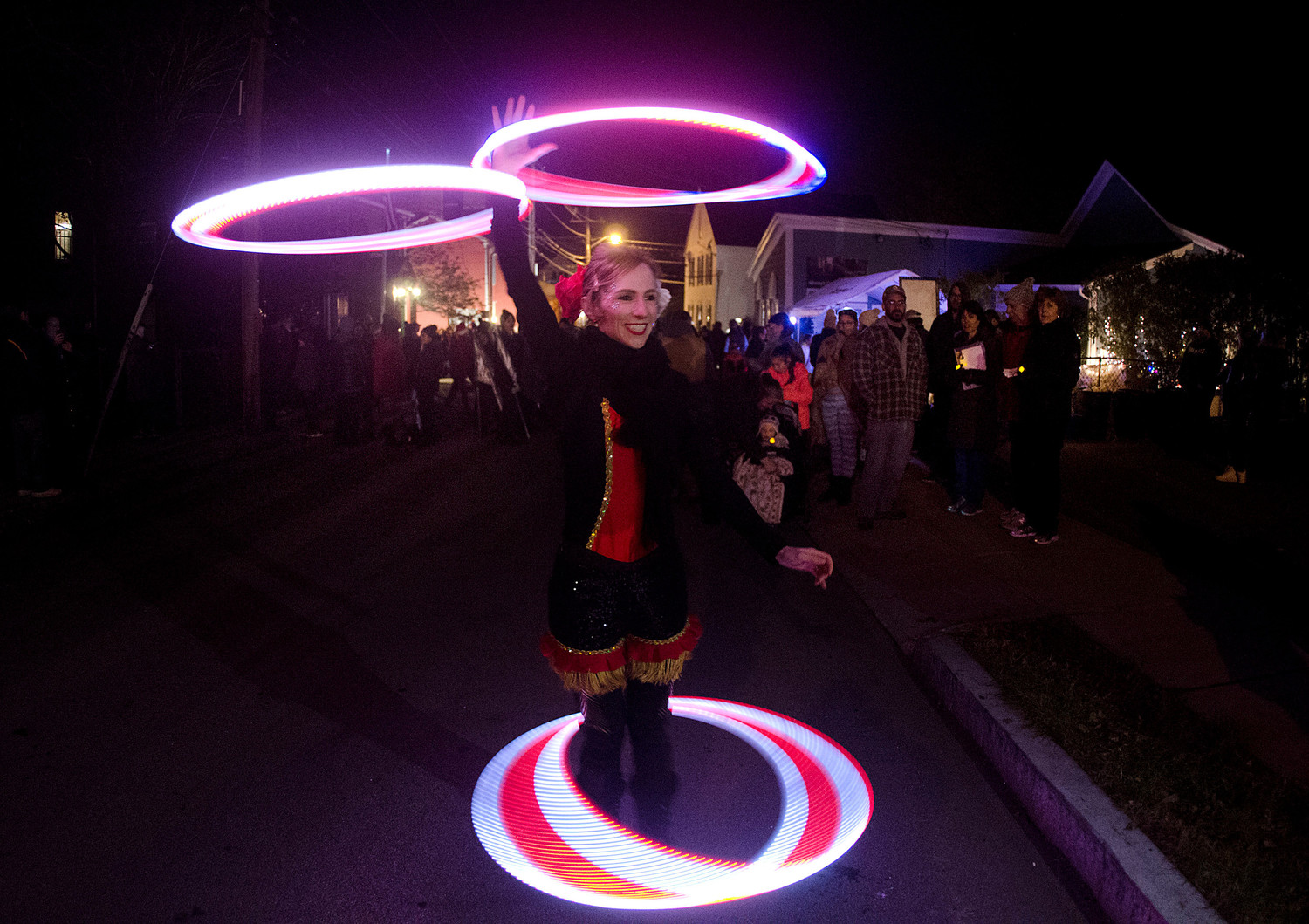 Little L of Circus Dynamics dances with lit hula hoops.
