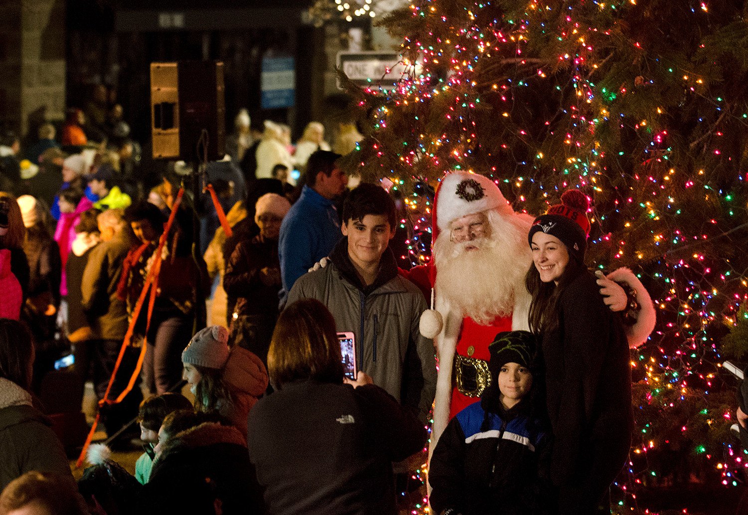 Santa takes photos with families after the lighting.