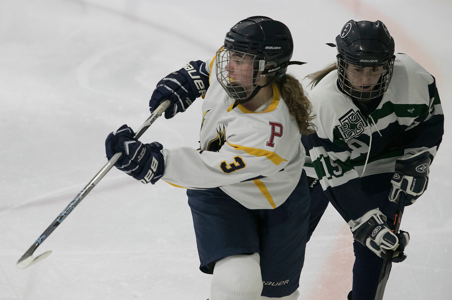 Forward Madison Cornell passes the puck up ice in the third period. She had an assist in the second period on a goal by Madelyn Cox.