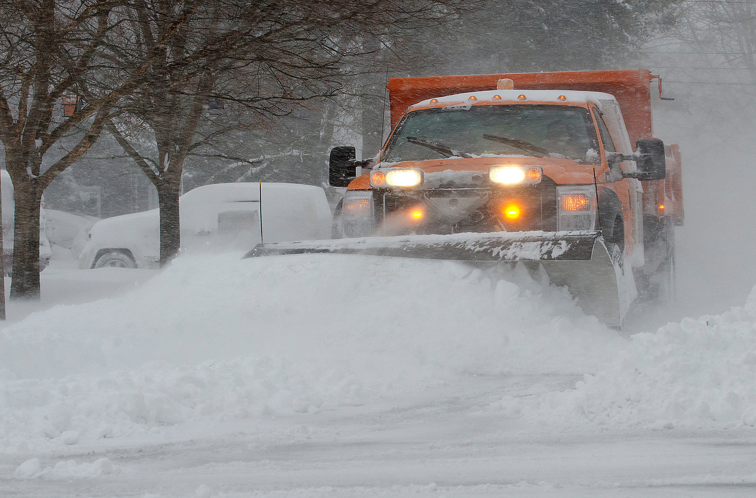 30 year Barrington DPW employee Mike Sousa plows Bullock Avenue during the blizzard on Thursday.