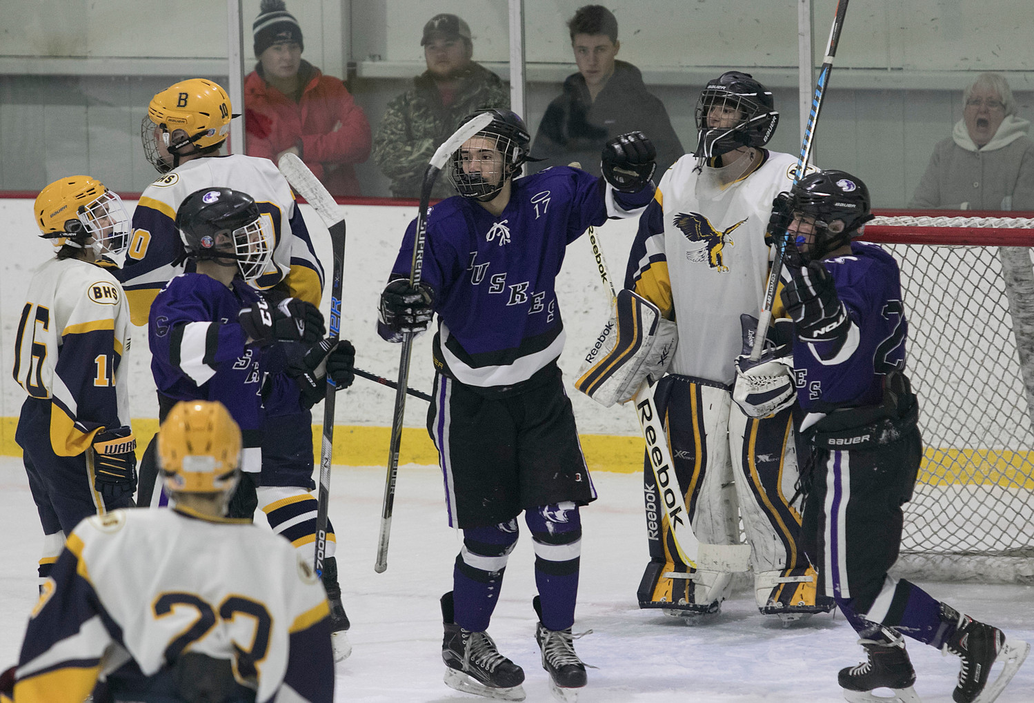 Huskies from left, Jared Rego, Chayton Powell and James Moreira celebrate after Rego scored to put the Mt. Hope on the scoreboard in the second period.