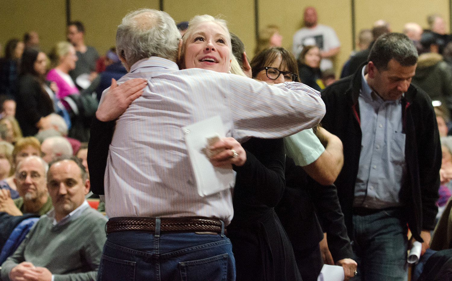 Tracy Priestner a member of the school building committee, receives a congratulatory hug after the vote.